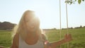 LENS FLARE,PORTRAIT: young woman in white swaying in sun struck nature. Royalty Free Stock Photo