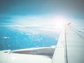 Lens flare and view of jet plane wing Royalty Free Stock Photo