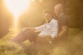 Lens flare, young couple in park, pregnant woman,