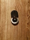 Lens peephole on new wooden door close up Royalty Free Stock Photo