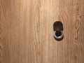 Lens peephole on new wooden door close up Royalty Free Stock Photo