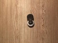 Lens peephole on new wooden door close up Royalty Free Stock Photo