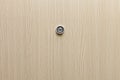 Lens peephole on new wooden door.