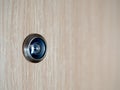 Lens peephole on wooden door Royalty Free Stock Photo