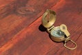A lensatic compass on a wooden table.