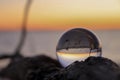Lensball capturing the red sunrise Royalty Free Stock Photo