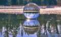 Lensball Reflections In A Puddle Of Water Royalty Free Stock Photo