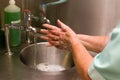 A Medical Professional Washing her Hands at a basin Royalty Free Stock Photo