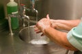 A Medical Professional Washing her Hands at a basin Royalty Free Stock Photo