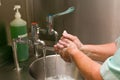 A Medical Professional Washing her Hands at a basin Royalty Free Stock Photo