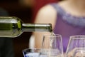 Close-up shot of white wine being poured in to a wineglass. Royalty Free Stock Photo