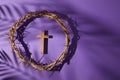 Lent season, Holy week and Good friday concept. Crown of torns and cross on purple background