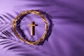 Lent season, Holy week and Good friday concept. Crown of torns and cross on purple background