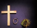 Lent Season,Holy Week and Good Friday concepts - photo of wooden cross,crown of thorns and palm leaves in purple vintage Royalty Free Stock Photo