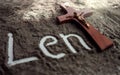 Lent word written in ash and christian cross as a T letter a religion concept Ash wednesday