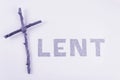 Lent word written in ash with Christian Cross. Concept for Lent Season, Holy Week, Palm Sunday and Good Friday.