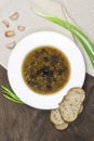 Lenten vegetarian soup with wild mushrooms, pearl barley, fresh herbs and healthy cereal bread, vertical