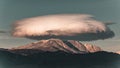 Lenticular cloud over snow-capped mountain range - AI generated Royalty Free Stock Photo