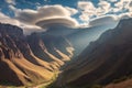 lenticular clouds casting shadows on a mountain valley
