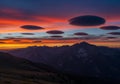 Lenticular clouds hover over a mountain Royalty Free Stock Photo