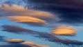 Lenticular clouds light up yellow as the sun sets, Yorkshire,UK Royalty Free Stock Photo