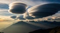 Lenticular clouds over mountain range at sunset Royalty Free Stock Photo
