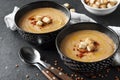 Lentil cream soup with paprika and crouton in black ceramic bowls Royalty Free Stock Photo