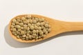 Lentil legume. Nutritious grains on a wooden spoon on white back Royalty Free Stock Photo