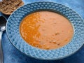 Lentil soup on blue grunge background. Royalty Free Stock Photo