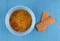 Lentil soup in blue mask on a blue background. Lentil soup with Royalty Free Stock Photo