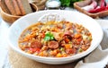 Lentil soup with chicken and pepperoni sausage, onion, carrot, sweet pepper, garlic and parsley. Royalty Free Stock Photo