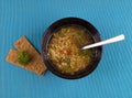 Lentil soup with herbs in black mask on a blue background. Lenti Royalty Free Stock Photo