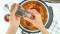 Lentil soup recipe, cooking using modern multi cooker. Woman adds black pepper