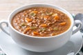 Lentil soup with vegetables in bowl on wood Royalty Free Stock Photo