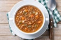Lentil soup with vegetables in bowl on wooden table Royalty Free Stock Photo