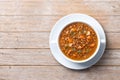 Lentil soup with vegetables in bowl on wooden table Royalty Free Stock Photo