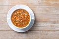 Lentil soup with vegetables in bowl on wooden table Royalty Free Stock Photo