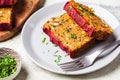 Lentil vegan meatloaf slices on gray plate. Christmas plant-based recipe