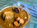 Lentils with chorizo, black pudding and bacon, spoon with checkered napkin Royalty Free Stock Photo