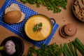 Lentils or pea soup-puree with parsley, onions, garlic barn bread and rye crackers on wooden rustic table. Organic food Royalty Free Stock Photo