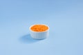 Lentils in a plate on top, on a blue background
