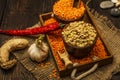 Lentils seeds on a wooden table with sackcloth. Seeds of red and green dietary supplements of lentils. Useful lentils of the legum Royalty Free Stock Photo