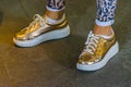 Woman With Golden Sneakers Royalty Free Stock Photo