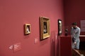 Leopold Museum, Wien - aug 2019: A tourist is looking at three paintings from a Young Gustav Klimt in a Purple wall.