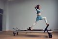 Leotard workout pilates training. athletic pilates reformer exercises. pilates machine equipment. young asian woman
