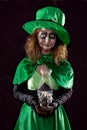 Leprechaun girl with a portable light, black background, concept