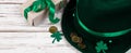 Leprechaun hat, gold coins, clover shamrock and gift with green ribbon on white background. Good luck symbols for St. Patrick`s Royalty Free Stock Photo