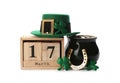 Leprechaun`s hat, block calendar and St. Patrick`s day decor on white background