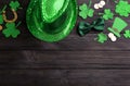 Leprechaun`s hat and St. Patrick`s day decor on black wooden background, flat lay. Space for text Royalty Free Stock Photo