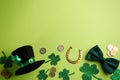 Leprechaun`s hat and St. Patrick`s day decor on green background, flat lay. Space for text